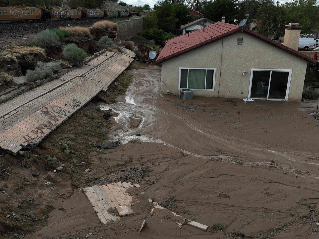 Mud fills the backyard of a home after a retaining wall partially collapsed when tropical storm Hilary moved through the area in Palmdale, California. Picture: Getty Images/AFP