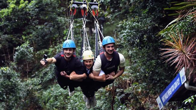 World Para Surfing champion Sam Bloom has visited Skypark Cairns while on a family holiday with her husband and sons, to show that inclusive travel is possible in Far North Queensland's World Heritage regions and award winning attractions. Sam Bloom (centre) rides the giant swing at Skypark with 2 of her 3 sons Oli Bloom and Noah Bloom. Picture: Brendan Radke