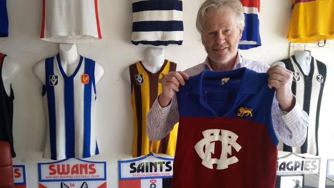 Wayne Jordan with John Murphy’s Fitzroy jumper from the Queen’s 1970 MCG visit. To his right: a North Melbourne jumper worn by Wayne Schimmelbusch. Picture: Daniel Cencic