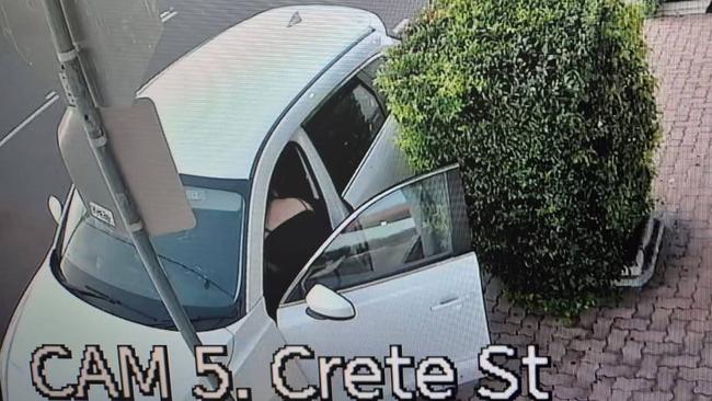 CCTV captured two people waiting for the woman outside the shop near a stolen white Mazda CX-9. Picture: Facebook/ Natalie Lucas