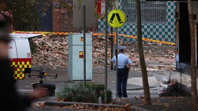 A police officer surveys the damage at first light on Friday. Picture John Grainger