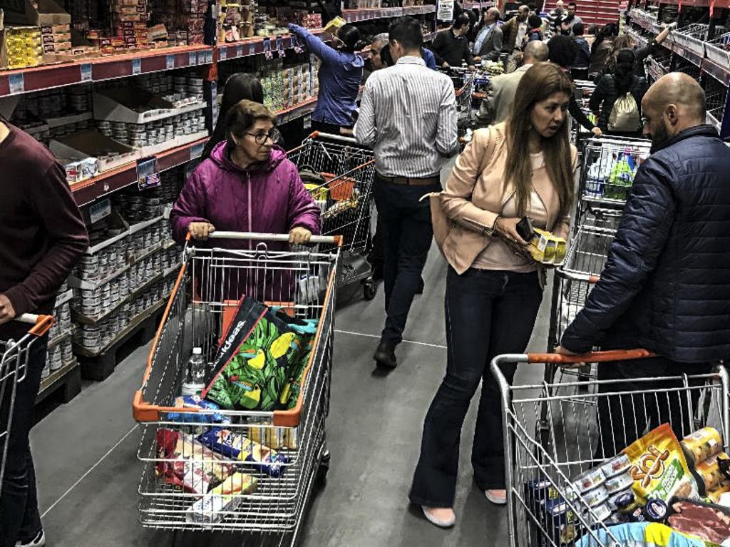 Fears of a nationwide quarantine have seen shoppers flood supermarkets in a bid to stock up on essentials. Picture: Daniel MUNOZ / AFP