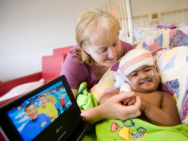 Latest released photos of separated twins Krishna and Trishna in the Royal Children's Hospital. Krishna and guardian Moira Kelly watch the Wiggles. Photo by Robert Reitmaier.