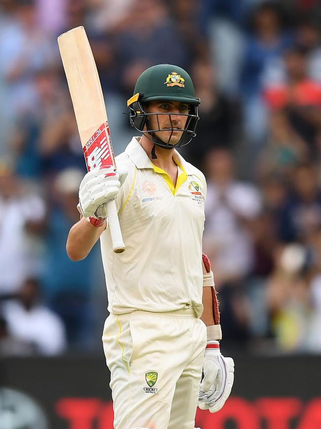 Cummins salutes after reaching 50. Picture: Getty