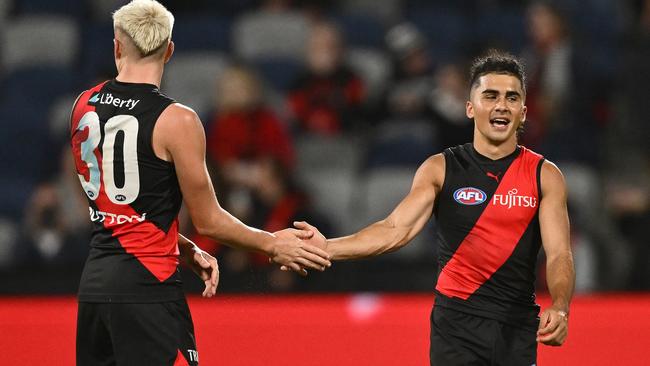 GEELONG, AUSTRALIA - FEBRUARY 25: Nate Caddy and Isaac Kako of the Bombers celebrate winning the 2025 AAMI AFL Community Series match between Geelong Cats and Essendon Bombers at GMHBA Stadium on February 25, 2025 in Geelong, Australia. (Photo by Quinn Rooney/Getty Images)