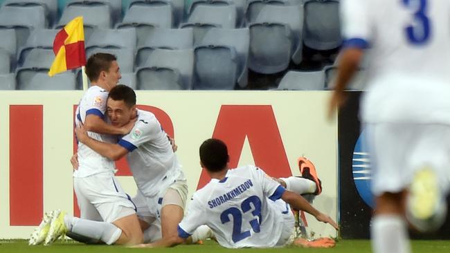 Anzur Ismailov of Uzbekistan (L) celebrates scoring a goal.