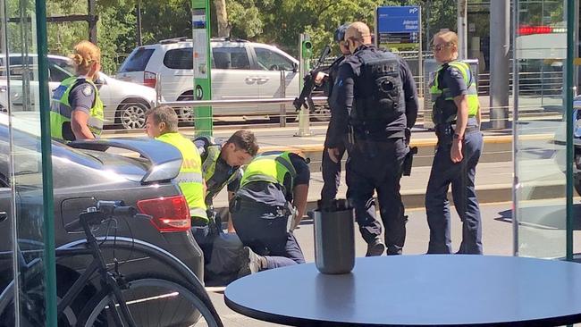 Police with the man on Wellington Parade.