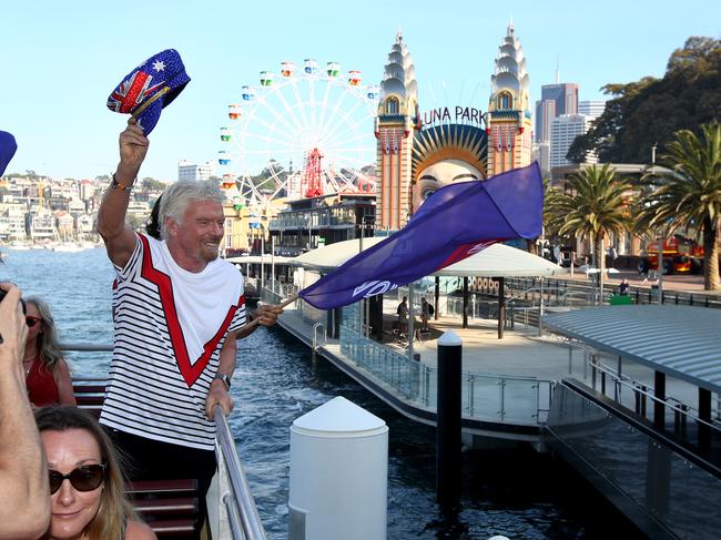 Sir Richard Branson greets commuters to announce Virgin Voyages and Virgin Australia will offer flight and cruise packages for Aussies wanting to cruise the Caribbean. Picture: Toby Zerna