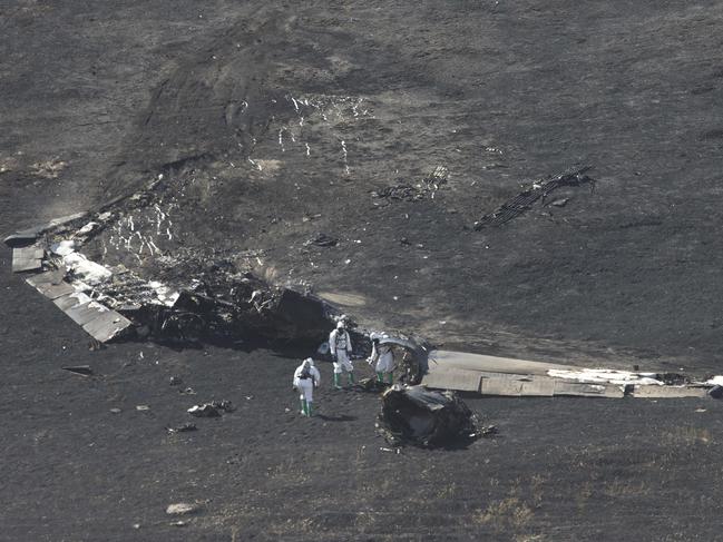 A U.S. Air Force Hazmat team inspects the wreckage of a U.S. Air Force U-2 spy plane that crashed in the Sutter Butte mountains, Tuesday, Sept. 20, 2016, near Yuba City, Calif. One pilot was killed and another injured when they ejected from the plane shortly after taking off from Beale Air Force base on a training mission. (AP Photo/Rich Pedroncelli)