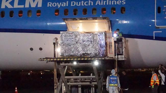 Workers unload containers carrying AstraZeneca vaccines from a passenger plane coming from Europe after arriving at the Ninoy Aquino International Airport in Manila. Picture: AFP