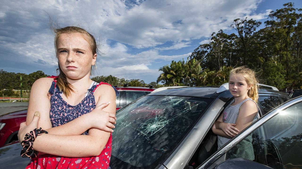 Sisters Izabella 10, and Chelsea Redman 7 from the Gold Coast, were in the car with dad Jason on the Bruce Highway at Glenview when a wild hailstorm hit causing chaos on the roads smashing windscreens and causing widespread damage. 'First the sky looked real black and the wind set in, then some small hail like bean bag filling before we stated to get peppered with golf and cricket ball sized stuff, it was quite scary, like getting peppered with gunshots' (Jason Redman). Photo Lachie Millard