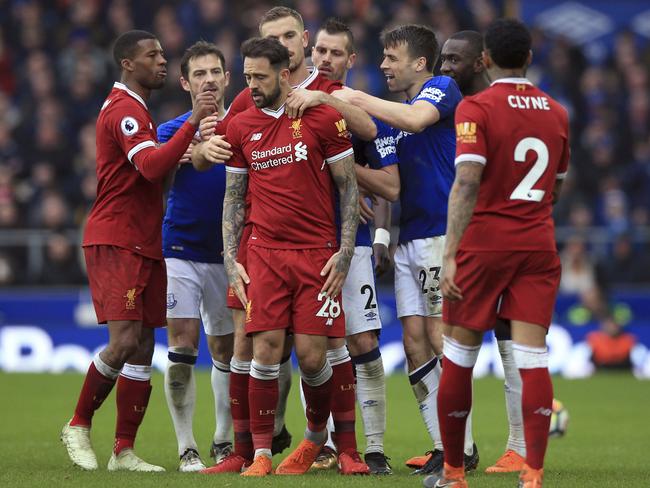 Liverpool's Danny Ings centre, and Everton's Seamus Coleman second right, are separated. (Peter Byrne/PA via AP)