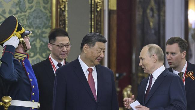 Russian President Vladimir Putin, right, and China President Xi Jinping talk during their meeting at the Kremlin.