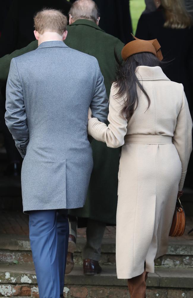 Meghan Markle and Prince Harry walking from the back. Picture: Getty