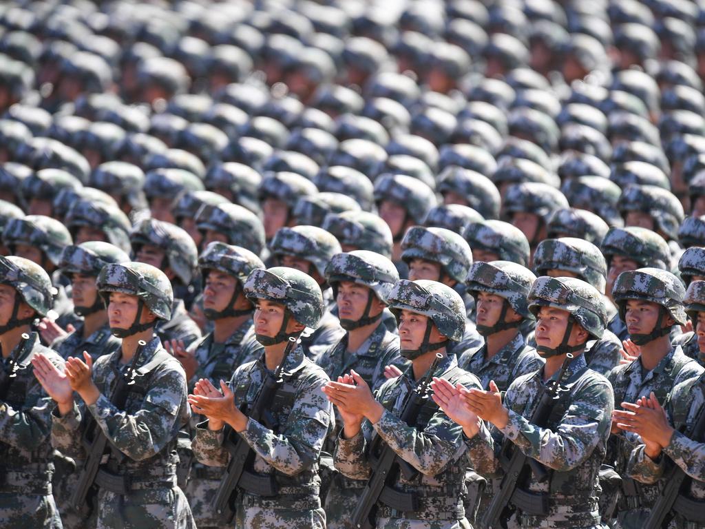 Chinese soldiers applaud during a military parade to mark the 90th anniversary of the People's Liberation Army. Picture: AFP