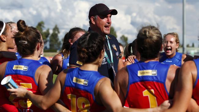 Lions coach Craig Starcevich sings the team song with his player. Picture: Dylan Burns/AFL Photos via Getty Images