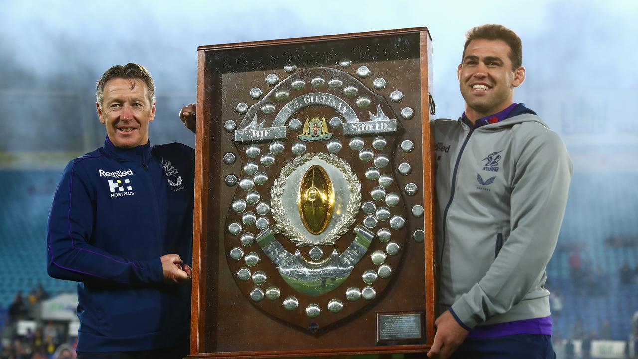 GOLD COAST, AUSTRALIA - SEPTEMBER 03: Storm coach Craig Bellamy and Dale Finucane of the Storm pose with the JJ Giltinan Shield after winning the minor premiership during the round 25 NRL match between the Cronulla Sharks and the Melbourne Storm at Cbus Super Stadium, on September 03, 2021, in Gold Coast, Australia. (Photo by Chris Hyde/Getty Images)