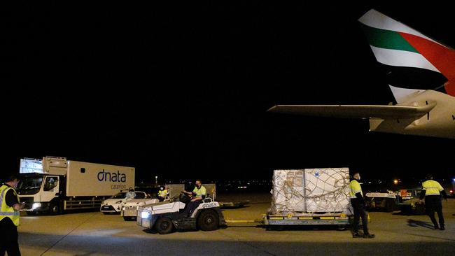 Airport workers transport pallets of the first shipment of the Moderna Covid-19 vaccination as it arrives at Sydney Airport on Friday. Picture: Getty Images