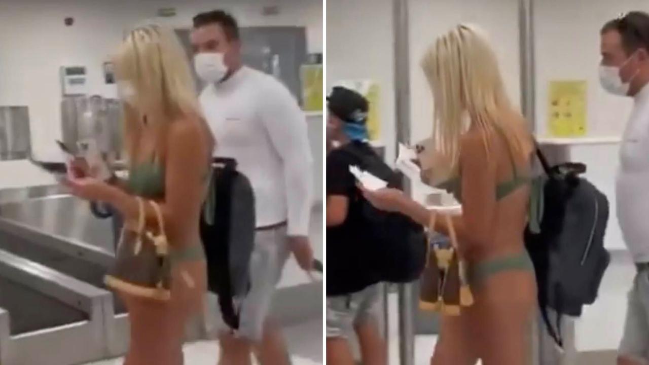 Woman walks through airport wearing thong bikini, video