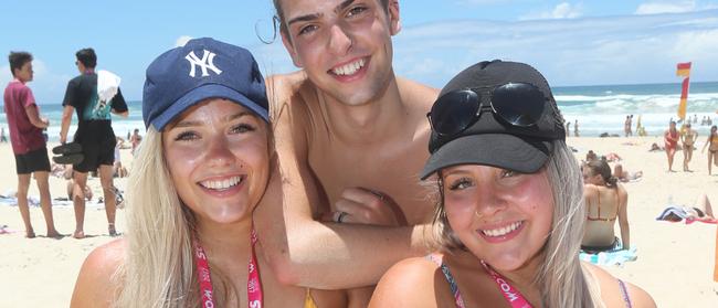 Schoolies from Southern States pictured stocking up on supplies and enjoying Surfers Paradise Beach. L-R Brittney Moorehouse, Declan Scott and Melissa Batsanes — plans are afoot to make the Schoolies beachfront festival one big fortnight with a paid ticket allowing major acts. Picture Mike Batterham