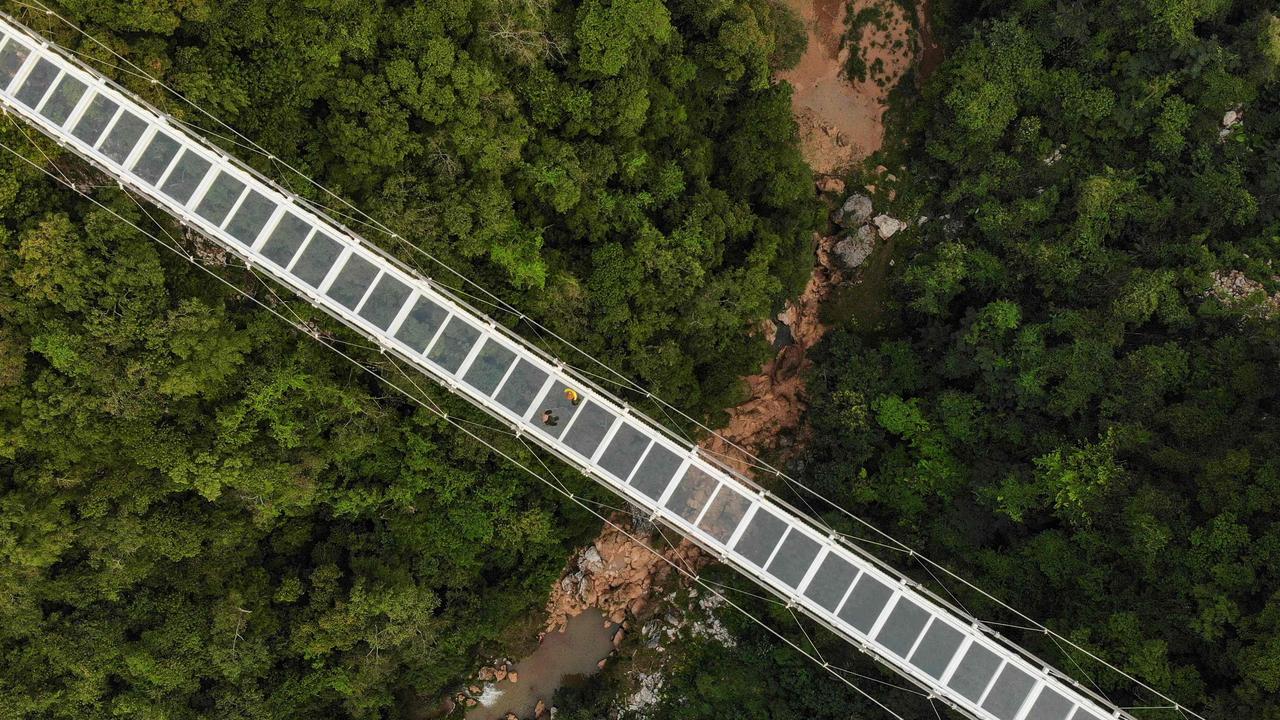 This aerial photo shows a portion of the newly constructed Bach Long glass bridge that sits 150m above a lush, jungle-clad gorge. Picture: Nhac Nguyen/AFP