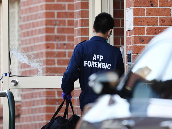 An AFP forensic officer enters a flat in Lakemba. Picture: AAP/David Moir