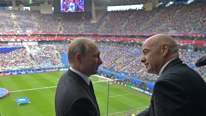Russian President Vladimir Putin, left, and FIFA President Gianni Infantino shake hands before the Confederations Cup, Group A soccer match between Russia and New Zealand, at the St. Petersburg Stadium, in St. Petersburg, Russia, Saturday, June 17, 2017. The Confederations Cup has kicked off with host nation Russia opening the World Cup rehearsal tournament against New Zealand. (Alexei Druzhinin/Sputnik, Kremlin Pool Photo via AP)