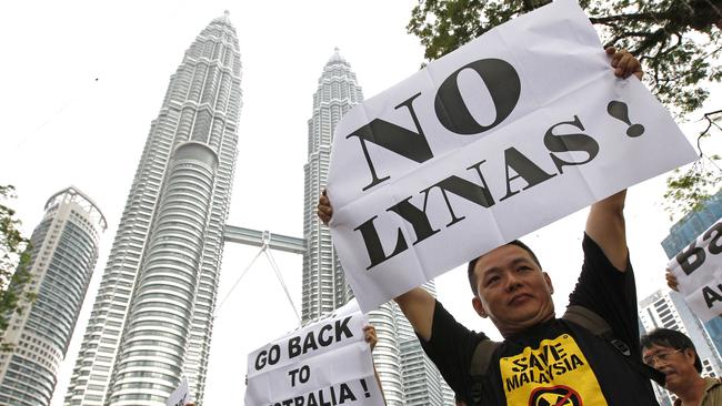 Activists hold placards during a demonstration against Australian miner Lynas in front of Malaysia's landmark Petronas Twin Towers in 2011.