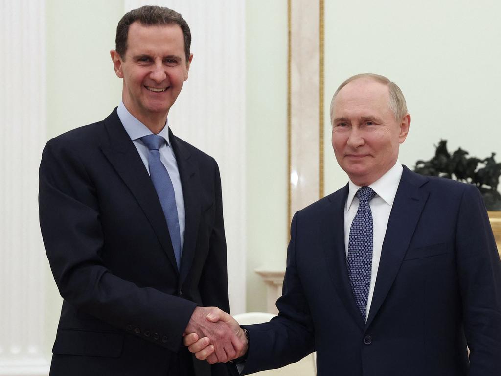 (FILES) In this file pool photograph distributed by the Russian state agency Sputnik, Russia's President Vladimir Putin (R) shakes hands with his Syrian counterpart Bashar al-Assad during their meeting at the Kremlin in Moscow on July 24, 2024. Islamist-led rebels declared that they have taken Damascus in a lightning offensive on December 8, 2024 sending President Bashar al-Assad fleeing and ending five decades of Baath rule in Syria. (Photo by Valery SHARIFULIN / POOL / AFP) / Editor's note : this image is distributed by Russian state owned agency Sputnik