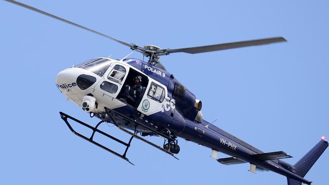 SYDNEY, AUSTRALIA - NewsWire Photos. December 1, 2020. NSW Police helicopter POLAIR 9 flies over the CBD.  Sydney, NSW. Picture: NCA NewsWire / Dylan Coker