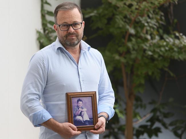 Brett Schatto, with a portrait of his son Jordan, who died just before his 10th birthday crossing the road in 2001. Picture: Emma Brasier