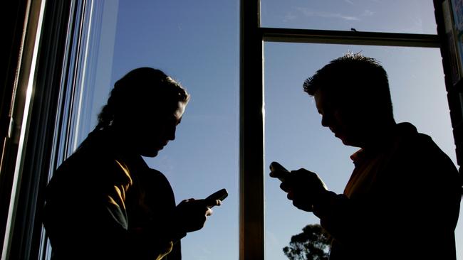 School kids on phones: too much screen time is leading to a lack of exercise, leading in turn to obesity.