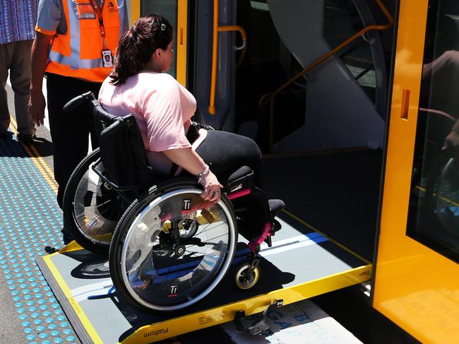 Wheelchair train passenger Pauline David at entering a train at Redfern station.