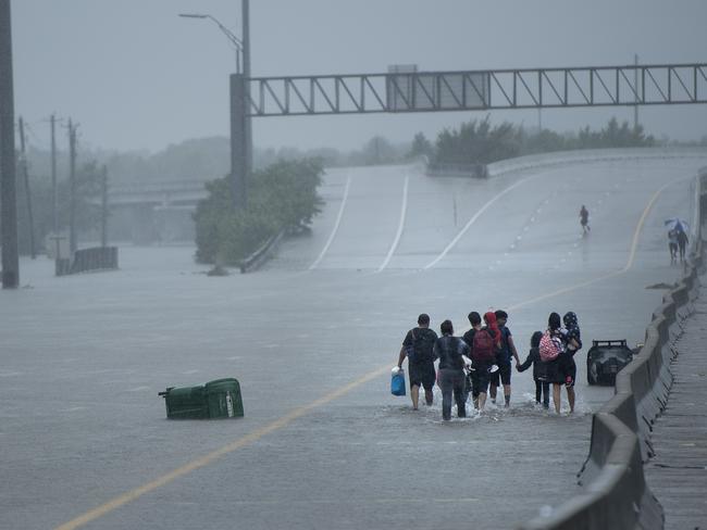 Evacuation residents from the Meyerland area walk onto an I-610 overpass for further help during the aftermath of Hurricane Harvey. Picture: Brendan Smialowski/AFP