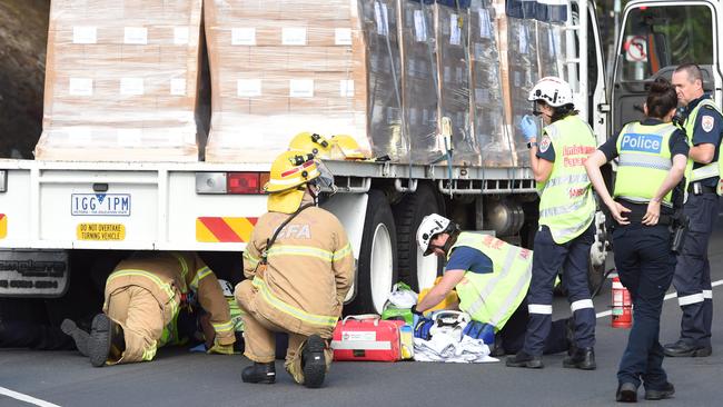 Emergency services workers attempt to free off-duty policewoman D’Arne Marie De Leo from beneath a truck driven by Samandeep Singh.