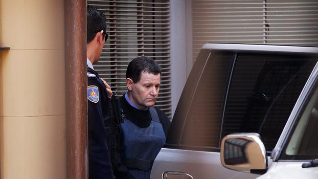 Former NSW police officer Mark Standen being led into King Street Court in the Sydney CBD.