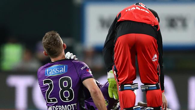 Ben McDermott, of the Hobart Hurricanes, reacts after being struck on the shoulder by a delivery from Dan Christian of the Melbourne Renegades. Picture: ROBERT CIANFLONE/GETTY IMAGES