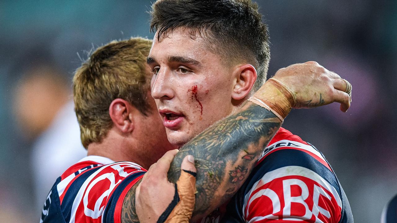 Victor Radley is embraced by Roosters skipper Jake Friend.