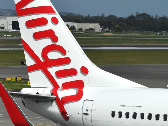 A Boeing 737-800 is seen at the Virgin Australia Airlines terminal at Adelaide Airport in Adelaide, Wednesday, August 28, 2019. Virgin Australia has reported a full-year loss of $349.1 million, saying it will cut 750 corporate and head office positions. (AAP Image/David Mariuz) NO ARCHIVING