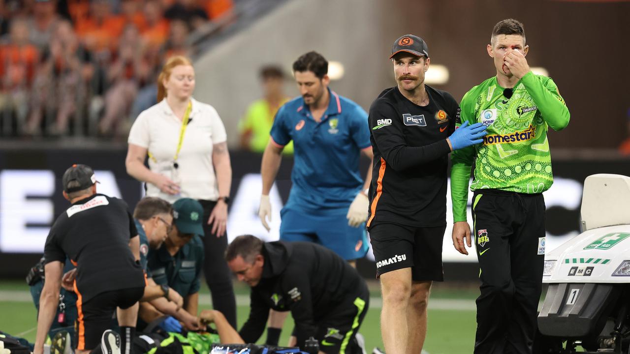 Cameron Bancroft is assisted from the field while medical staff attend to Daniel Sams. Picture: Paul Kane/Getty Images