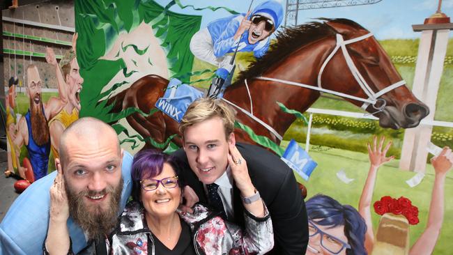 Debbie Kepitis with AFL stars Max Gawn and Tom Lynch in front on a Winx mural. Picture: David Caird