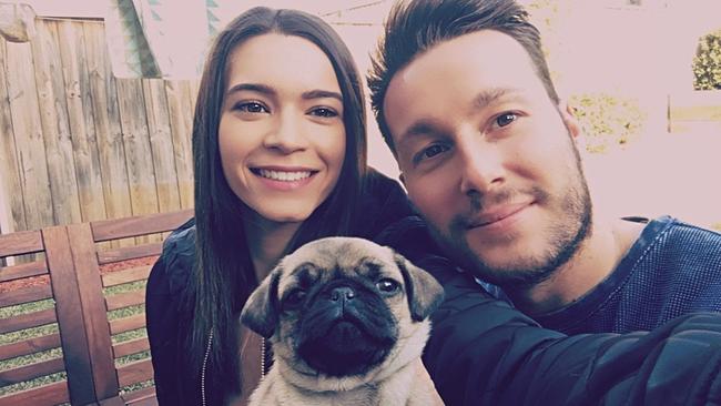 Bello the pug was stolen from a home in Kellyville when robbers broke in during the middle of the night. Pictured with Emily Haiden and partner Denis Tessari.