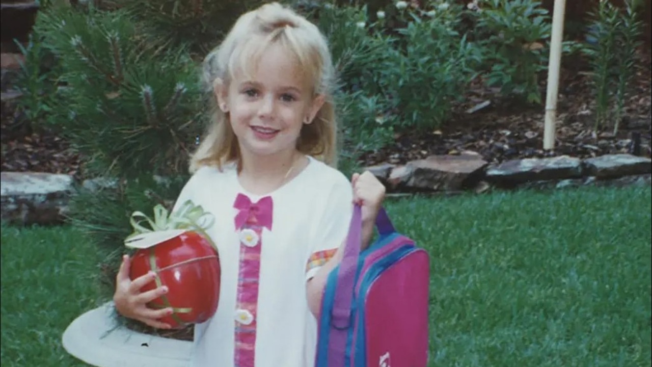 JonBenét Ramsey holds a backpack and plastic apple in an undated family photo. Picture: Ramsey family collection/ Discovery+