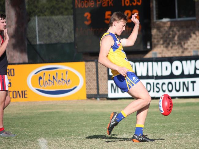 Bailey Lambert booting a goal for Noble Park