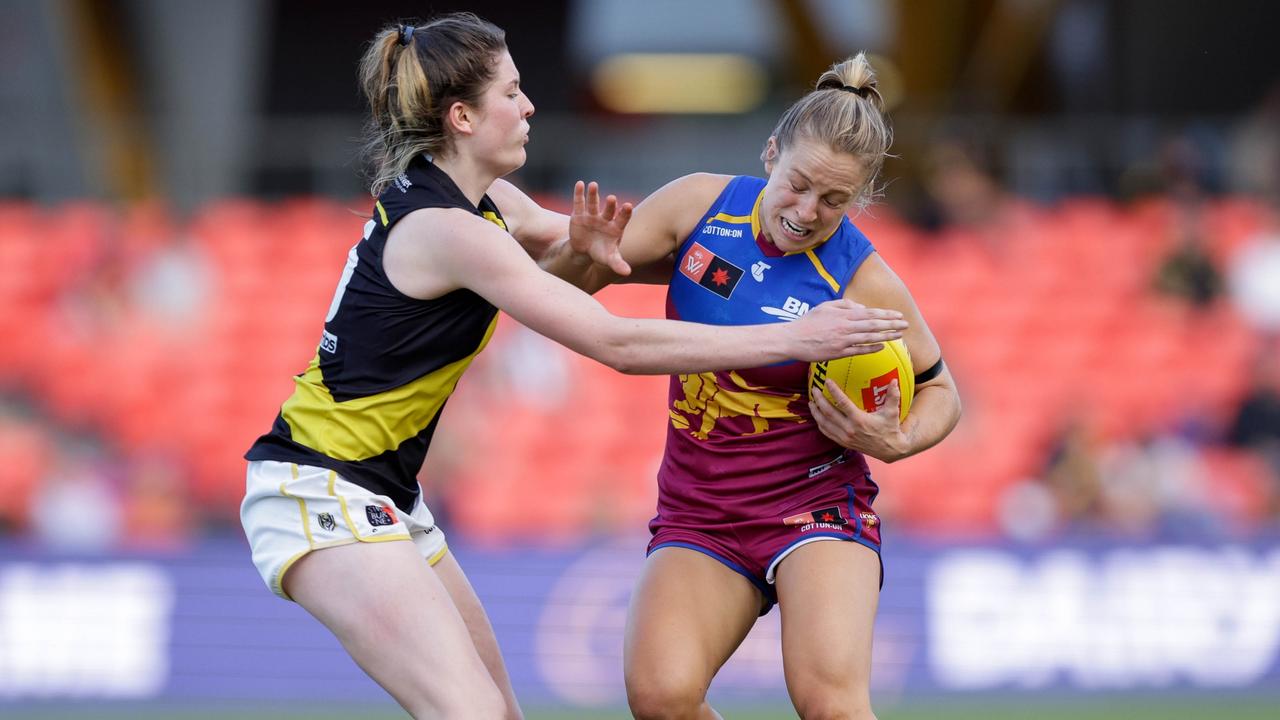 Isabel Dawes of the Lions is tackled during the 2022 S7 AFLW First Qualifying Final match between the Brisbane Lions and the Richmond Tigers at Metricon Stadium. Picture: Russell Freeman/AFL Photos via Getty Images