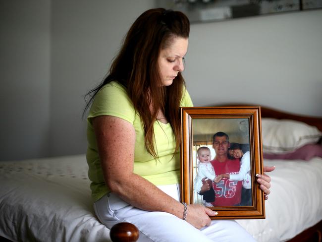 Sharon Tozer with a picture of her husband Mick. Read the story of how she and the families of other victims are searching for answer again, in the link above / Picture: Adam Taylor