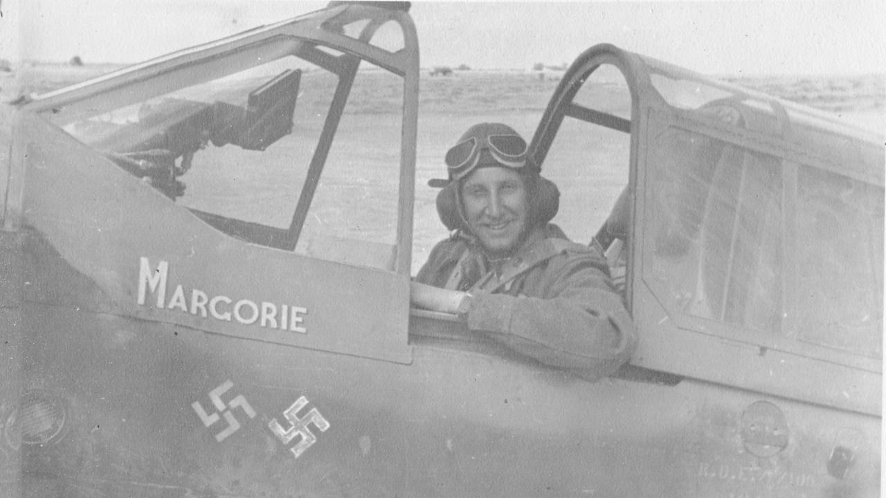 P/O Shaw, 20, in the cockpit of his Kittyhawk named Margorie after his fiance. The swastika markings denote two German kills. Picture: Operation Jacob