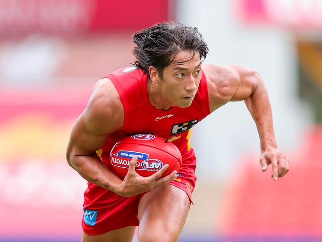 GOLD COAST, AUSTRALIA - FEBRUARY 25: Alex Davies of the Suns carries the ball during an AFL practice match between the Gold Coast Suns and Port Adelaide Power at Metricon Stadium on February 25, 2022 on the Gold Coast, Australia. (Photo by Russell Freeman/AFL Photos via Getty Images)