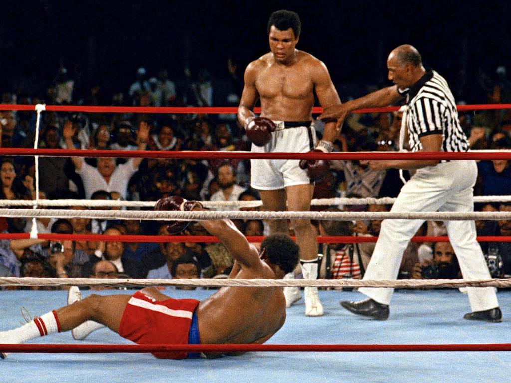 October 30, 1974: Referee Zack Clayton steps in after Ali knocks down George Foreman in the eighth round of the Rumble in the Jungle.