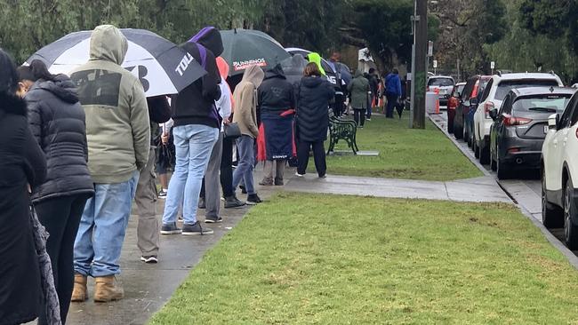 People are queuing in the rain as they wait to be tested for coronavirus at a pop-up site in Berwick. Picture: Suzan Delibasic